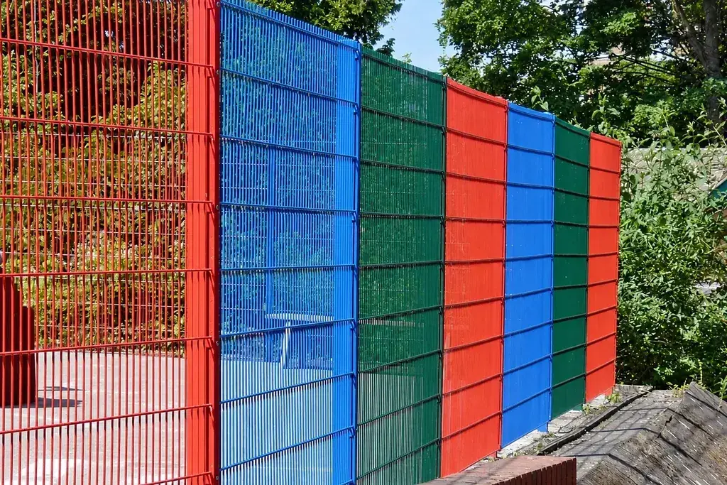 Colourful double wire fence panels viewed from the path