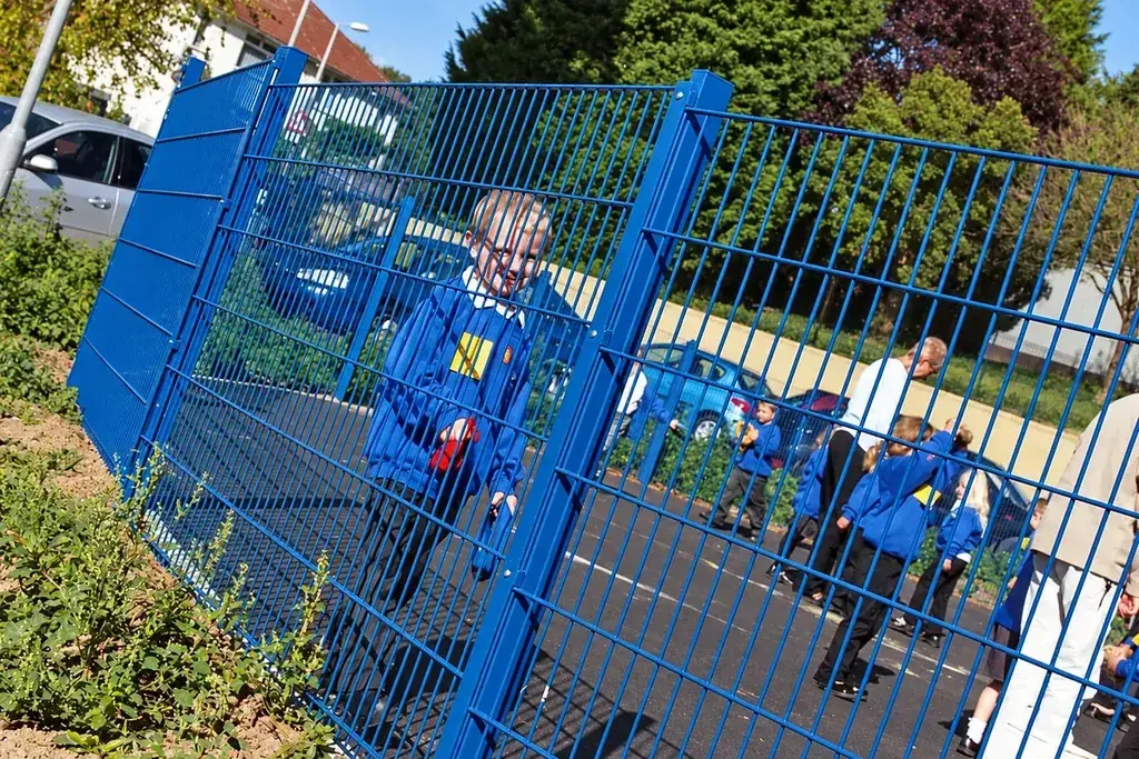 Blue double wire mesh fence around a recreation area