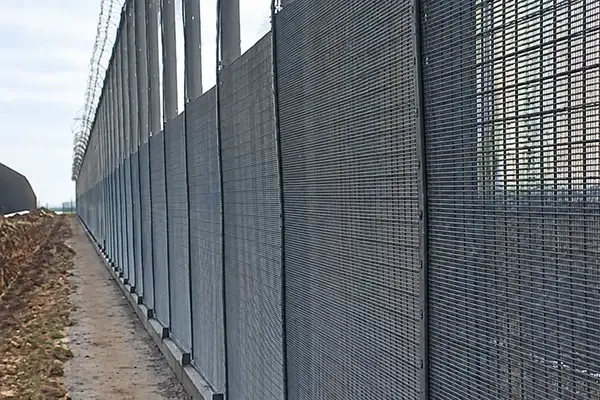 Two layer close mesh security fence viewed along the boundary