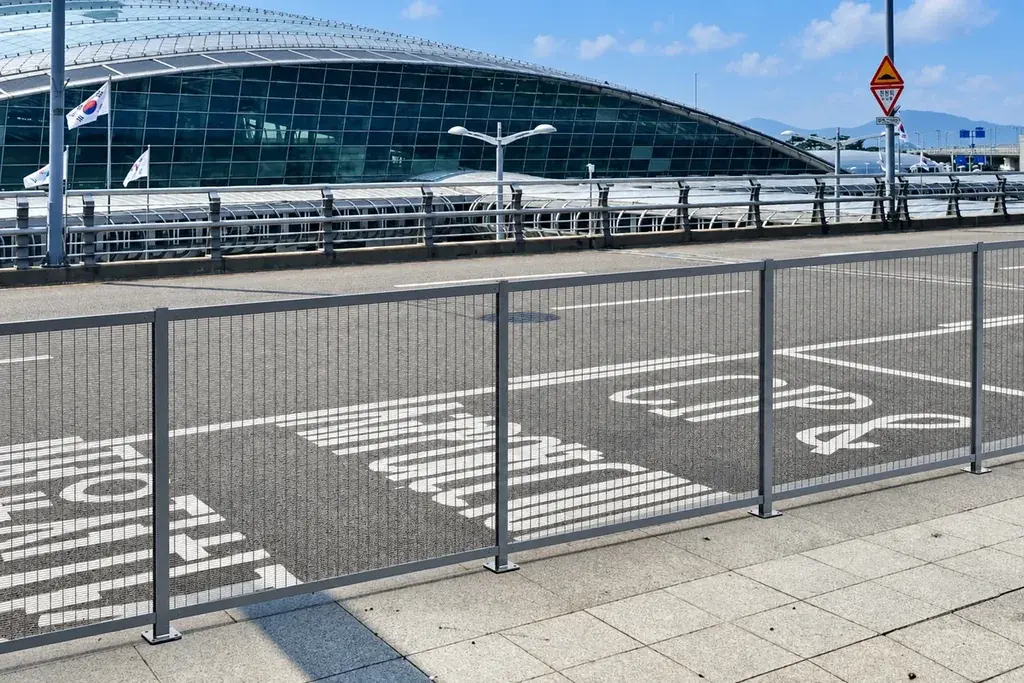 Close mesh security fence beside an airport building