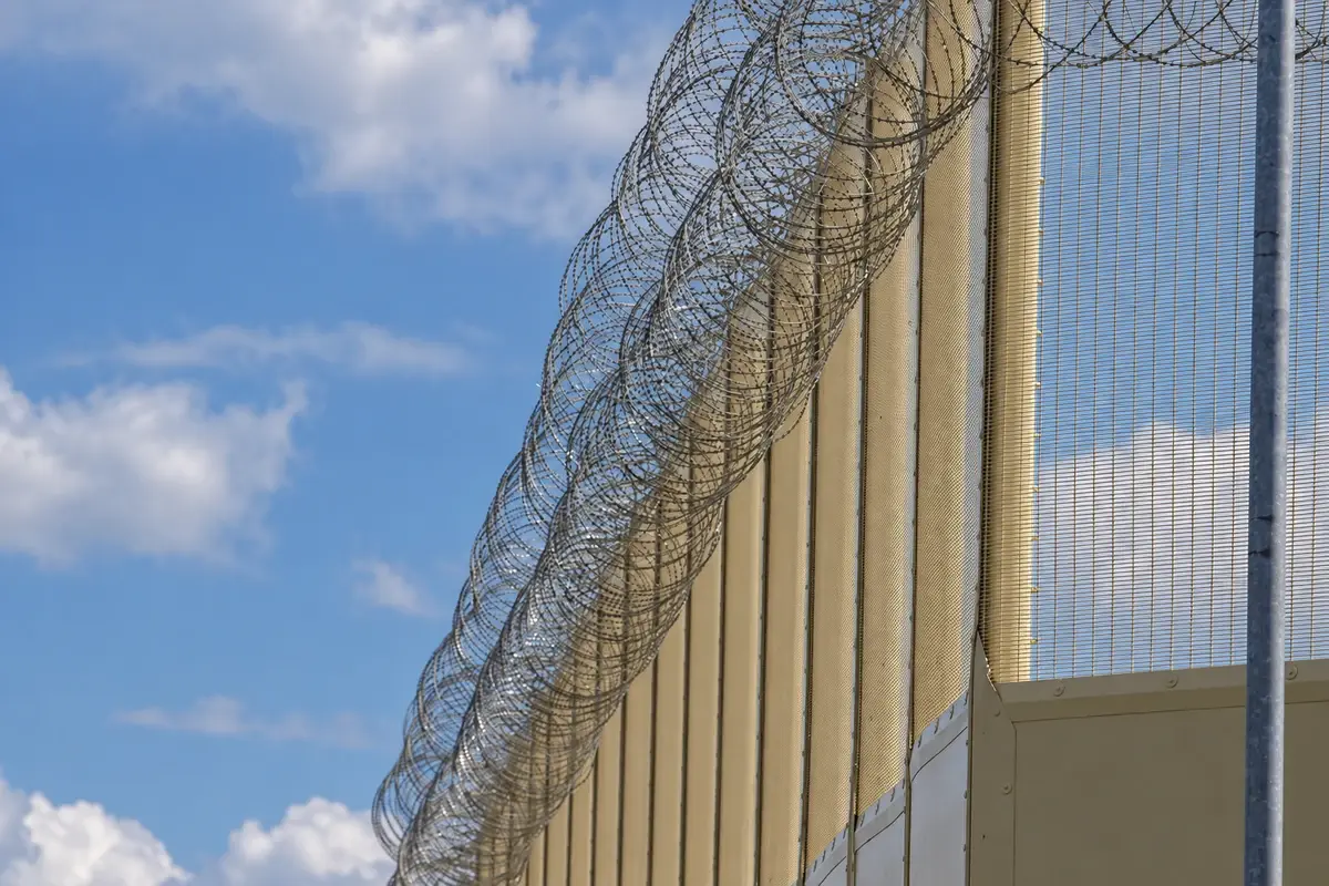 Tall close mesh fence with a separate security topping