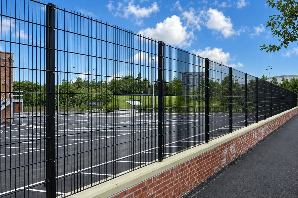 Flat double wire mesh panels along a paved boundary