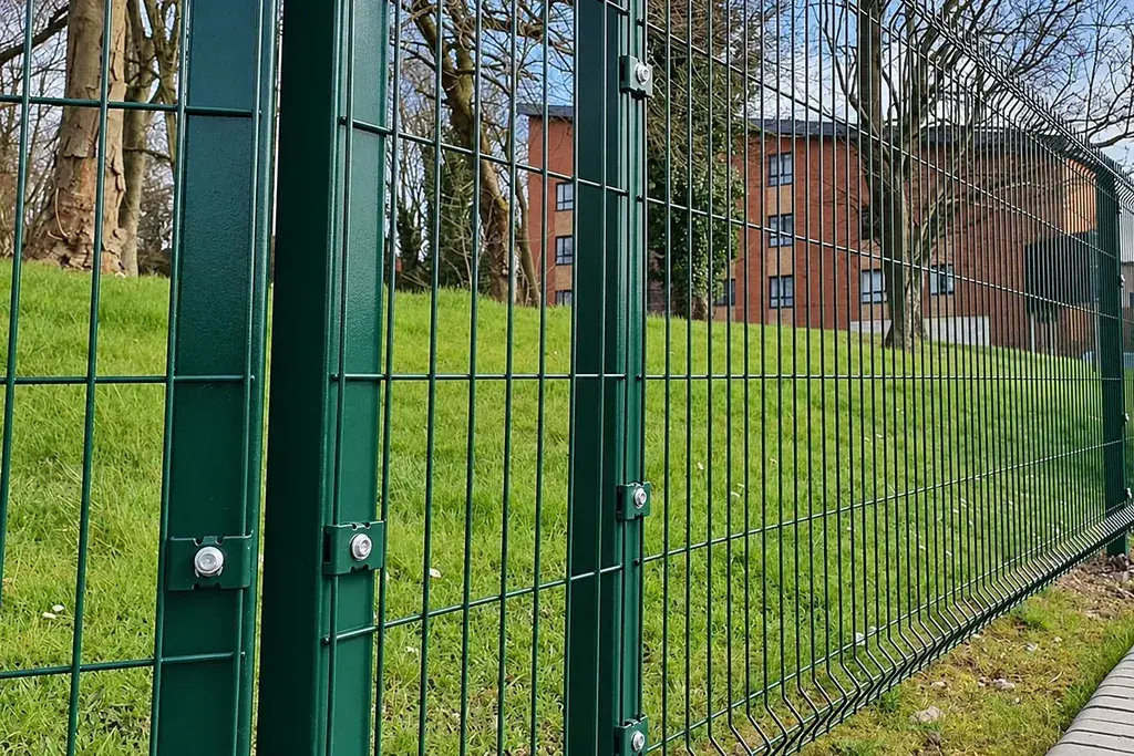 Green profiled mesh panel fixed to a square post near a V bend