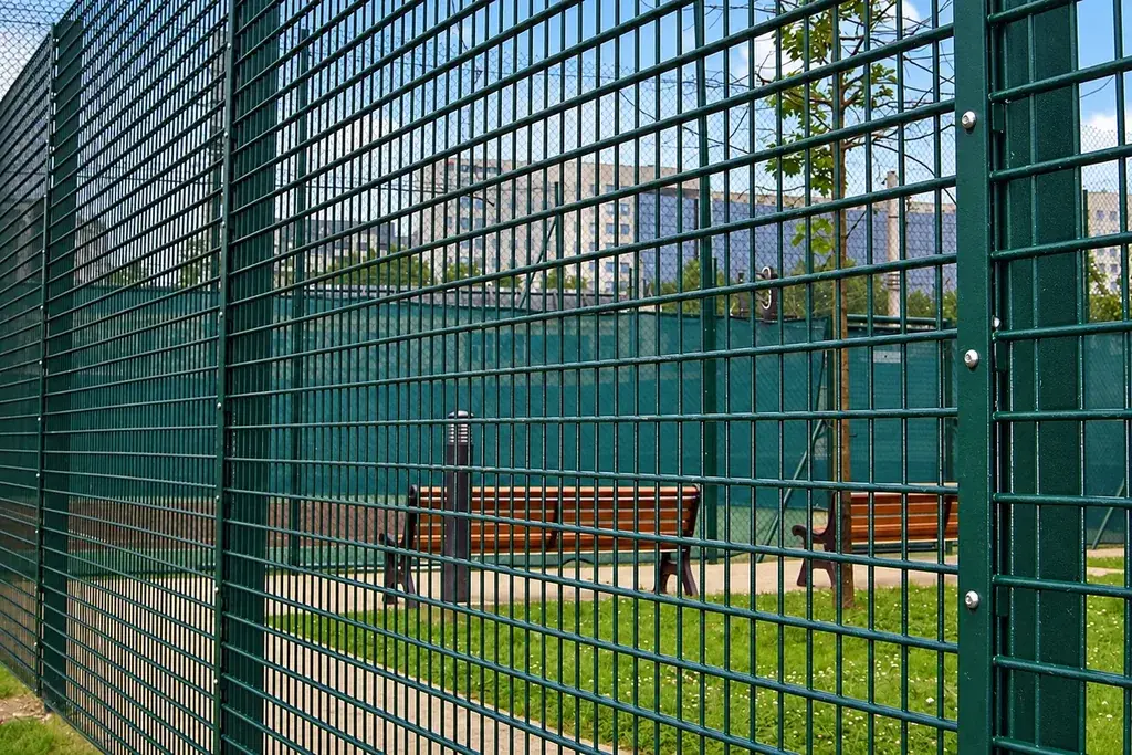 Sports rebound mesh fence enclosing a ball court
