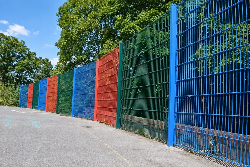 Colourful twin wire welded mesh panels installed along a pathway