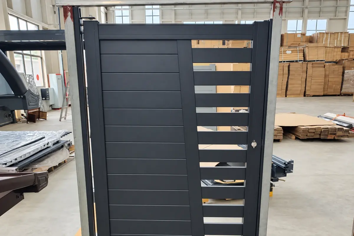 Dark aluminium slat panel in a workshop with several open spaces near one edge
