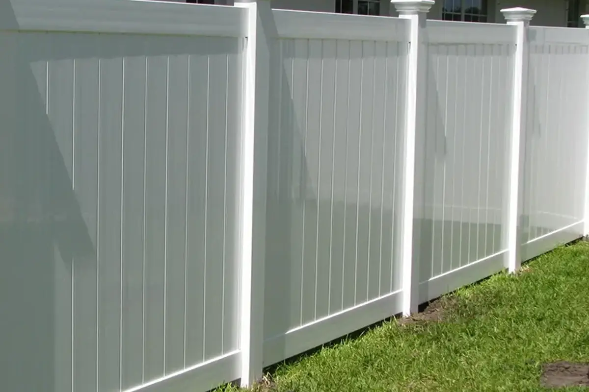 White PVC privacy fence made from solid-looking infill panels, rails and posts