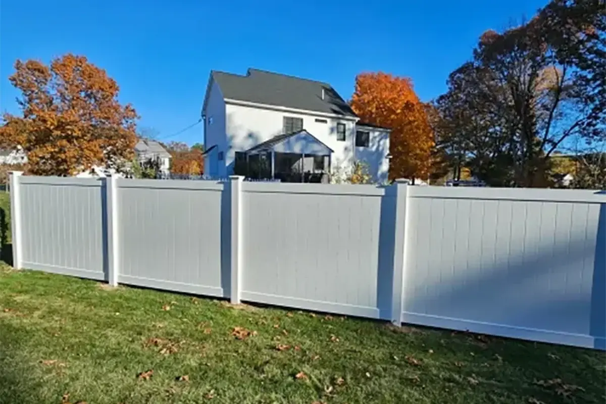 White PVC privacy fence panels and posts around a residential garden
