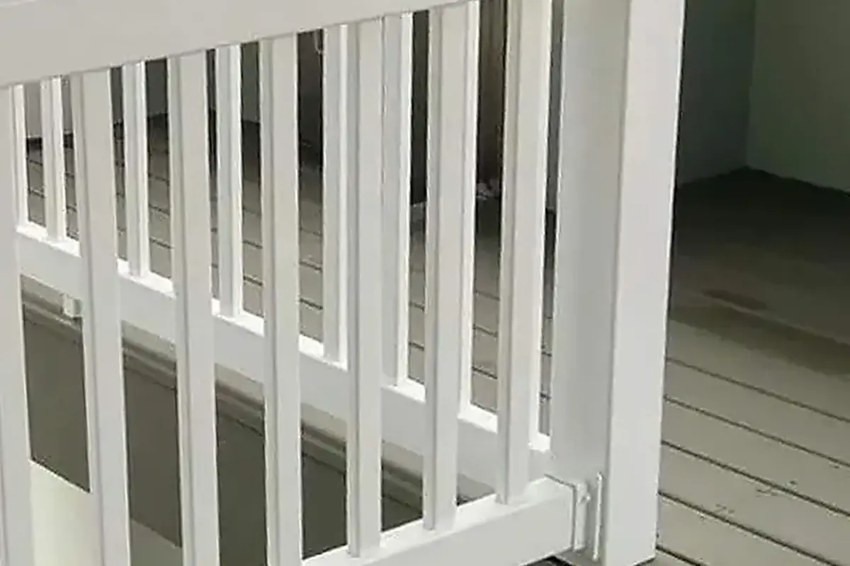 White vinyl fence rails and vertical infill attached beside a square post