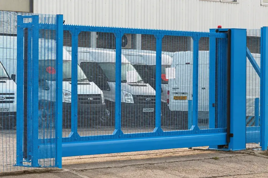 Blue cantilever sliding gate with a support section beside the opening