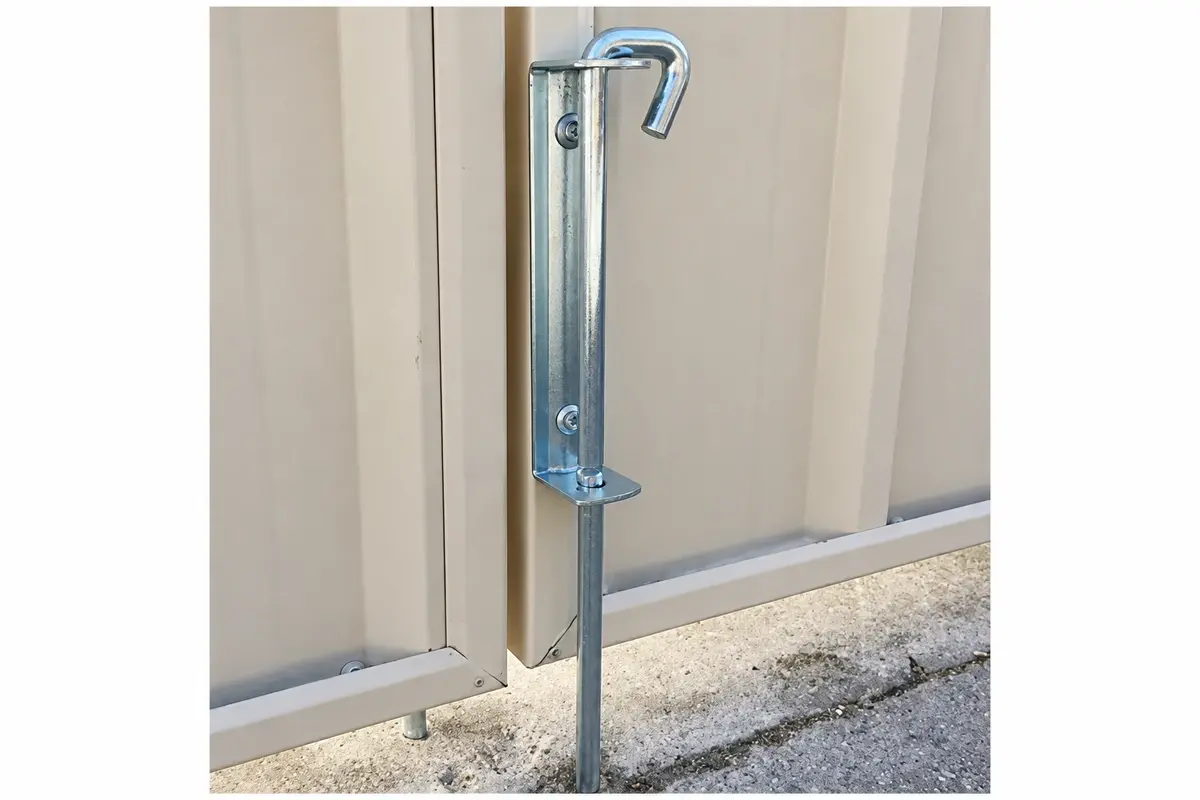 Metal drop bolt fixed to the lower edge of a gate