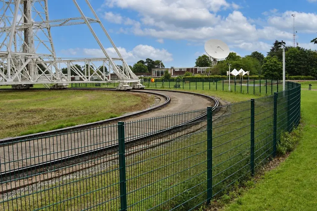 Dark twin-wire mesh fence following a curved site boundary