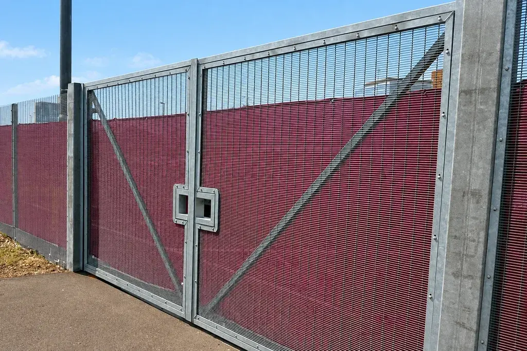 Double-leaf mesh swing gate hung between two gate posts