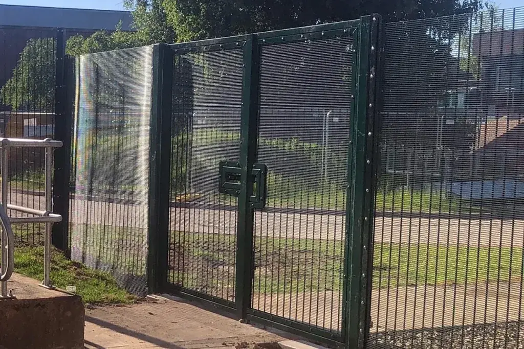 Double-leaf security gate with frame, hinge posts and meeting edges visible