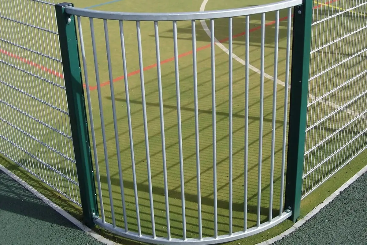 Metal fence panels meeting at a curved change in direction