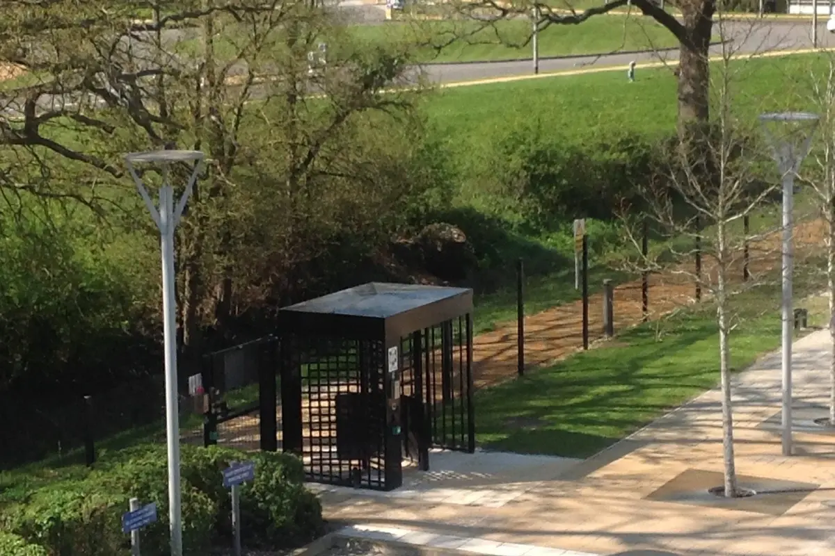 Pedestrian gate positioned along a fenced access path