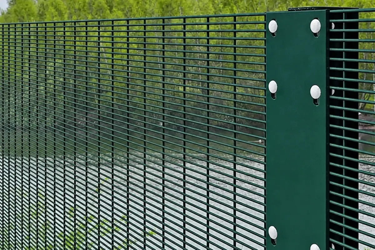 Close mesh fence panel fixed beside a post with a vertical bar and visible bolt heads