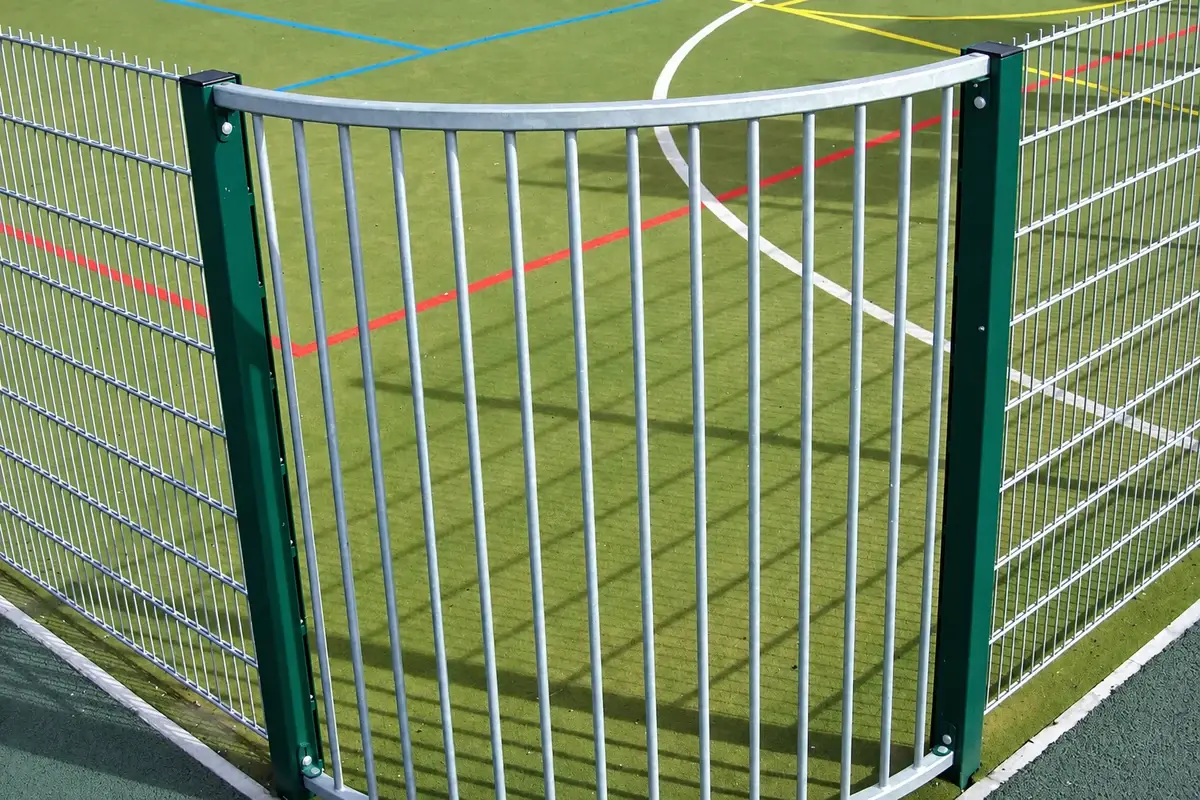 Rounded metal corner of a fenced sports court