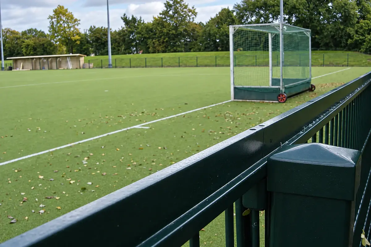 Hockey pitch with a goal and surrounding sports fence
