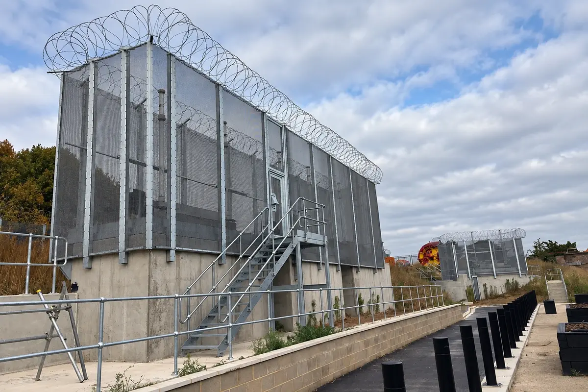 Metal mesh enclosure around water utility equipment