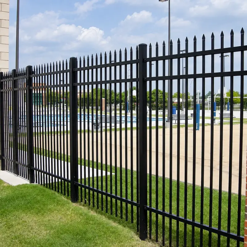Black metal fence panels and posts installed along a site boundary