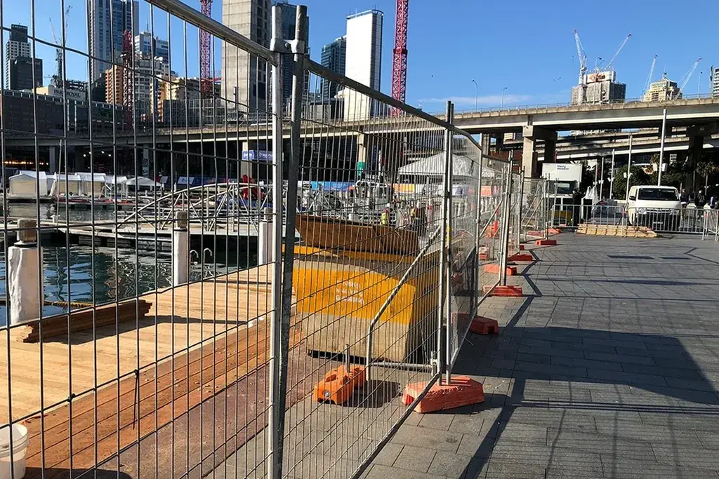 Temporary mesh fence panels defining a construction work zone