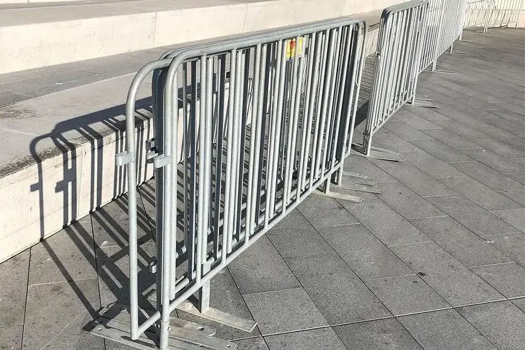 Interlocking metal crowd barriers along a pedestrian route