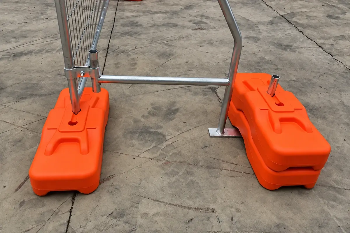 Temporary fence support brace connected to orange surface feet