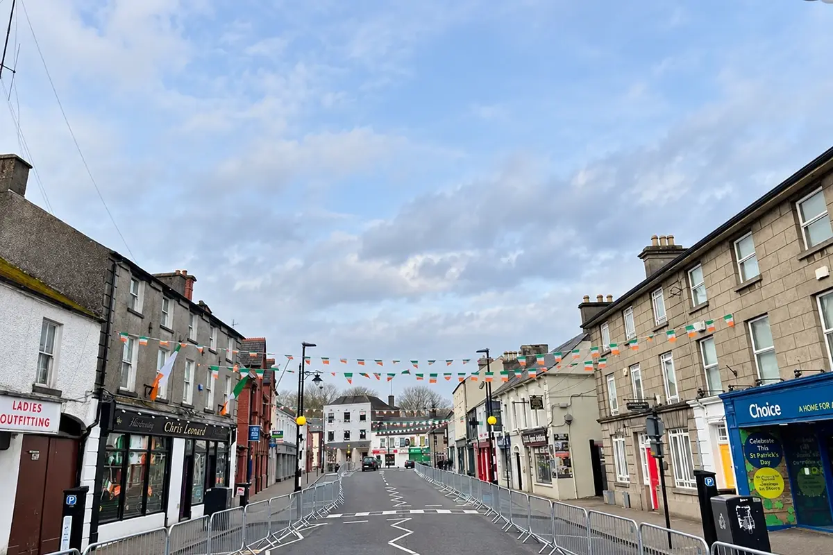 Urban street lined with shops and stone buildings