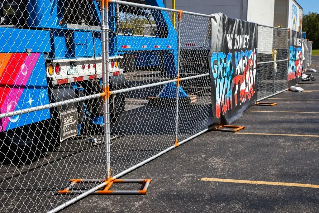 Temporary chain link fence beside a parked work vehicle