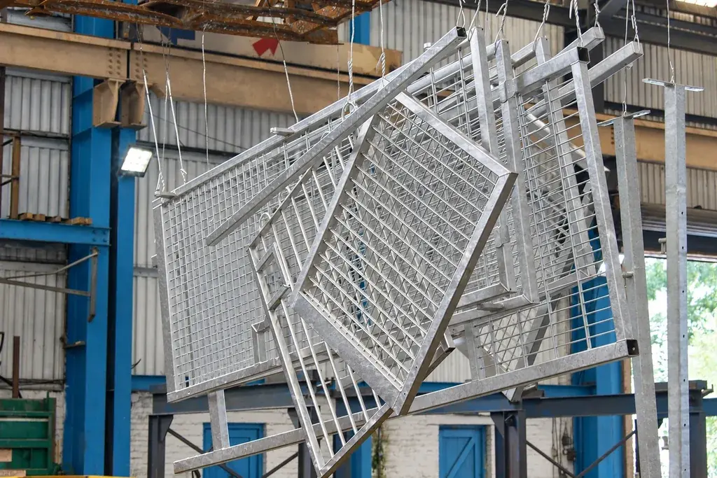 Fence panels suspended in a hot-dip galvanizing workshop