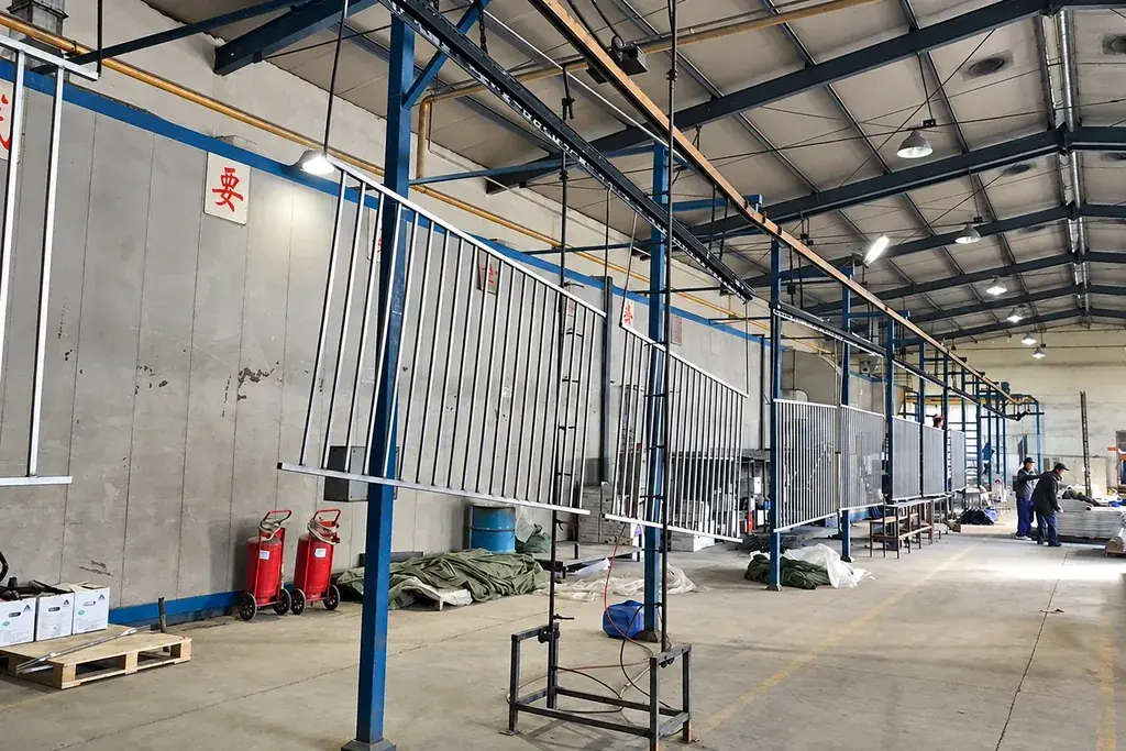 Fence panels suspended on an industrial coating line