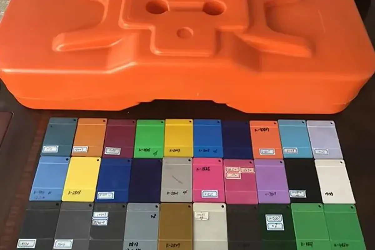 Rows of physical colour sample chips beside an orange fence component