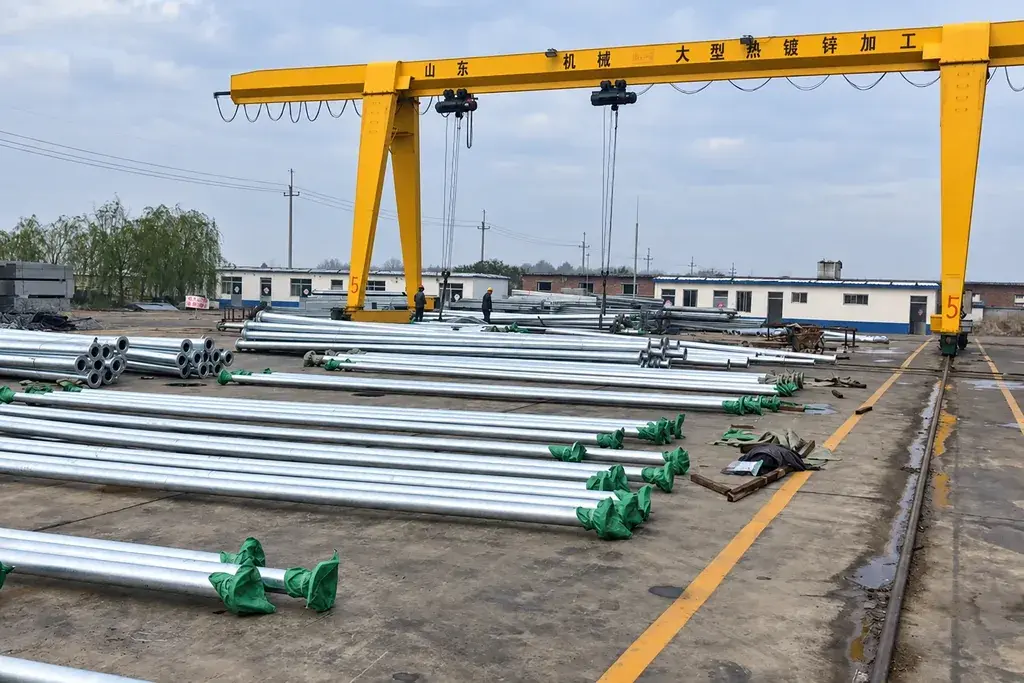 Galvanized steel fence sections laid out at a production site