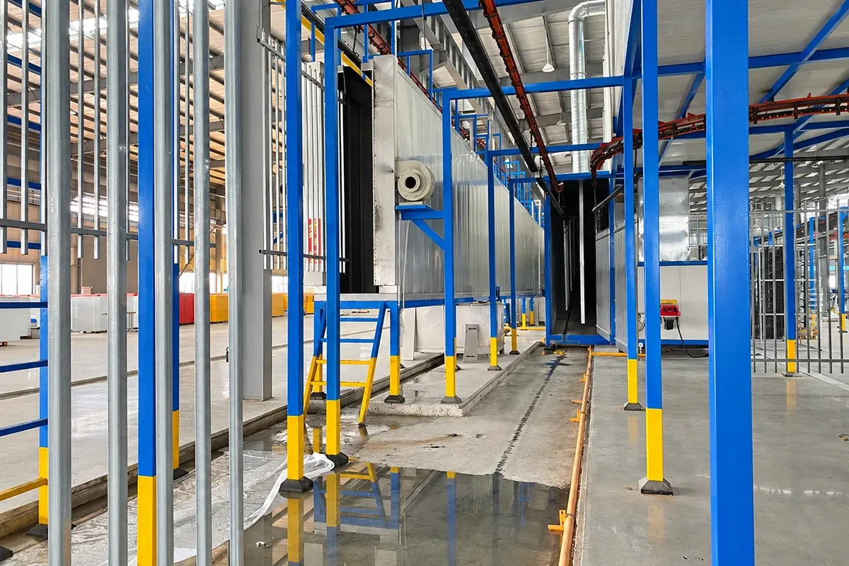 Metal fence components suspended on a powder coating line