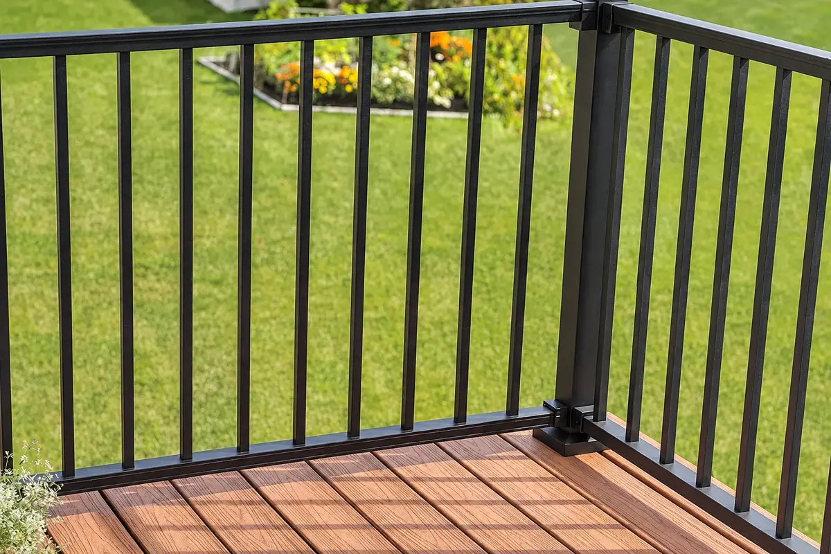 Black steel railing panels meeting at a deck corner