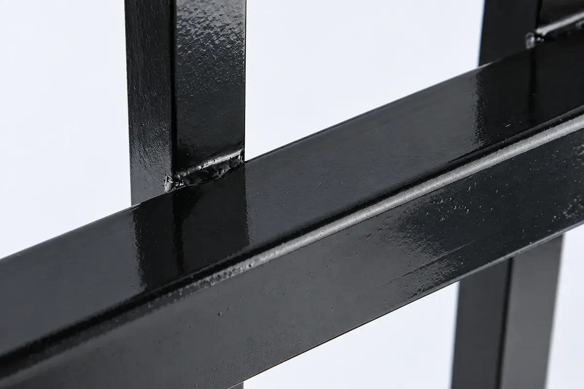 Close view of a coated steel fence bar and rail joint