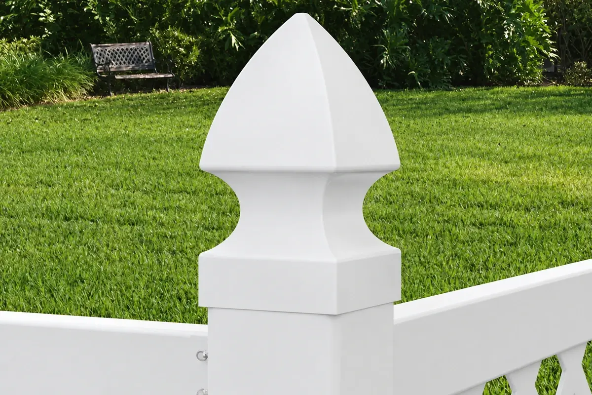 White pointed fence cap seated on a square post