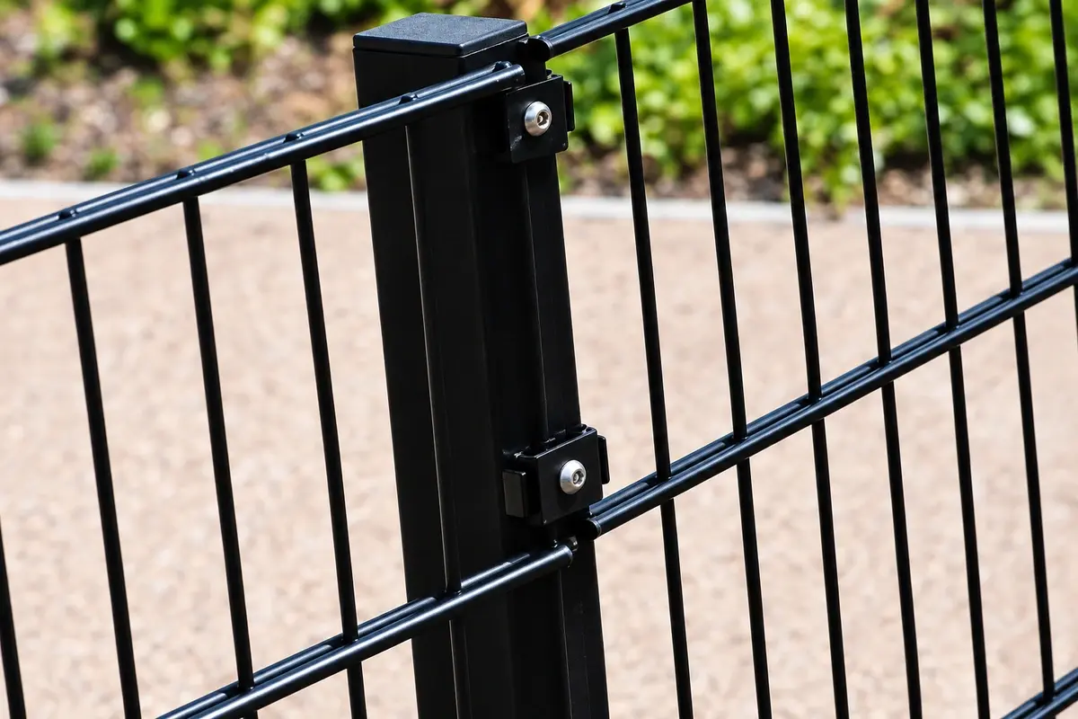 Close view of a steel fence panel connected to a post