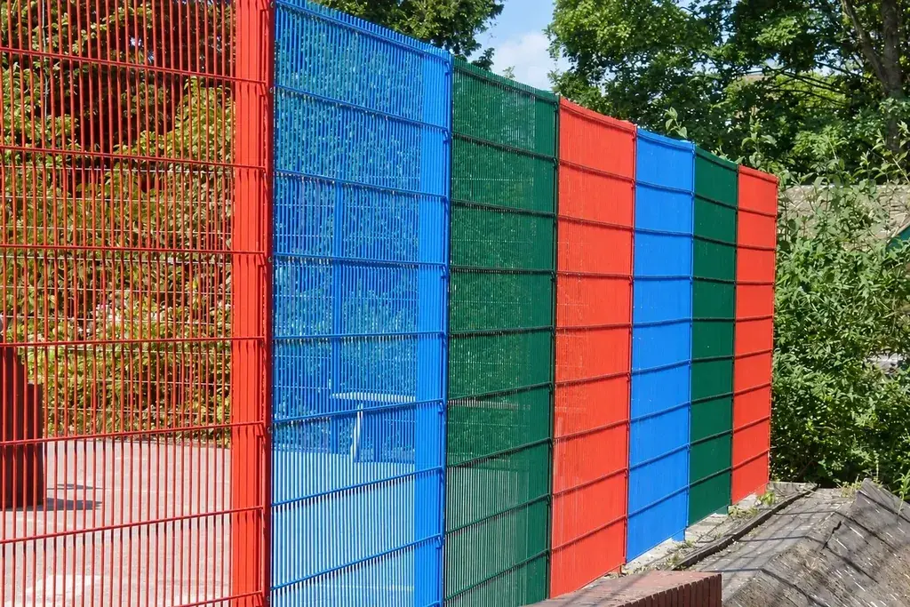 Installed twin-wire fence panels in several colours