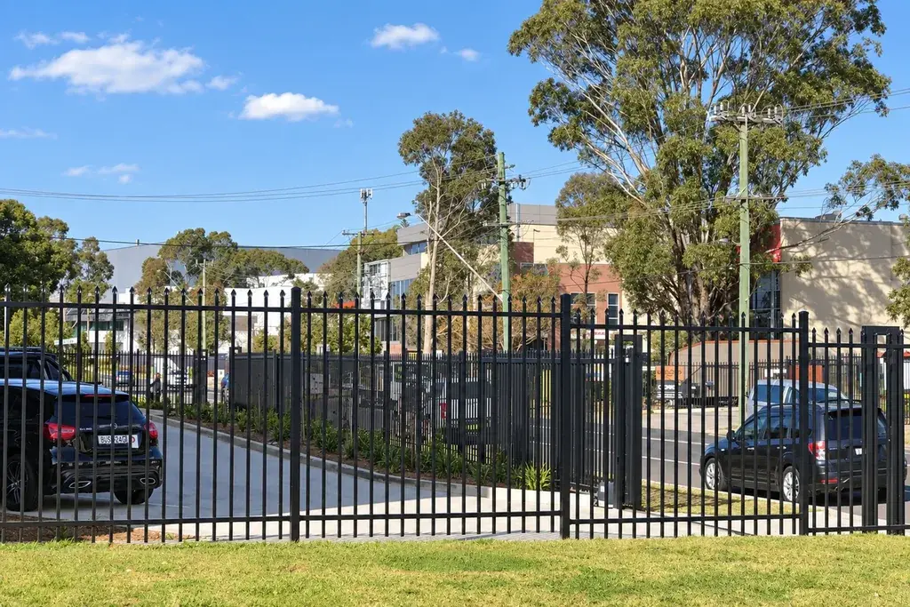 Black steel fence and matching gate at a site entrance