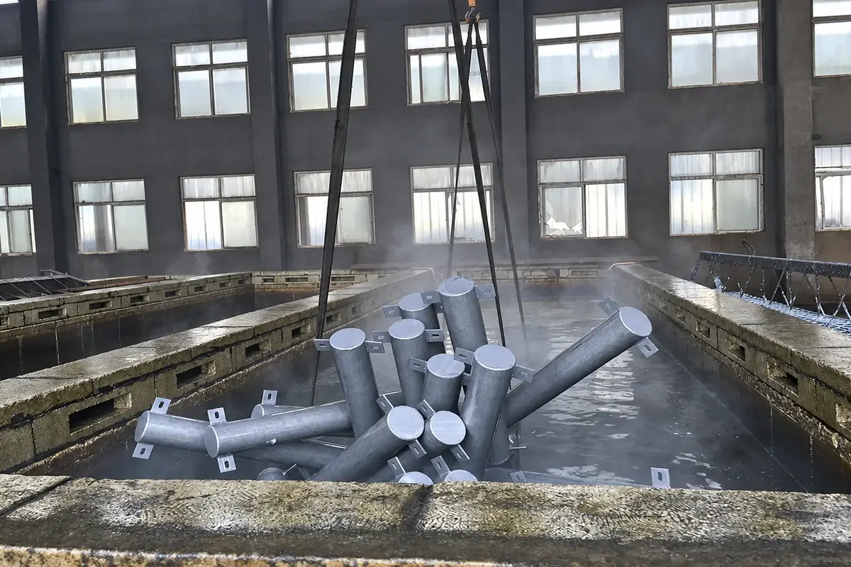 Steel parts being processed in a hot-dip galvanizing bath