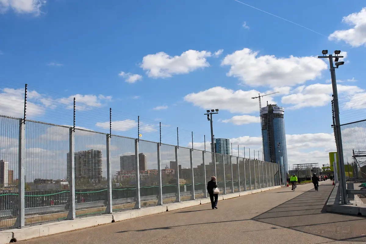 Security fence running alongside an industrial perimeter