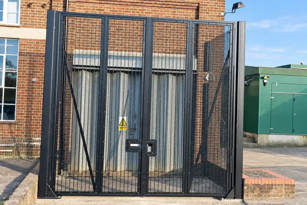 Black security mesh pedestrian gate mounted in a steel frame