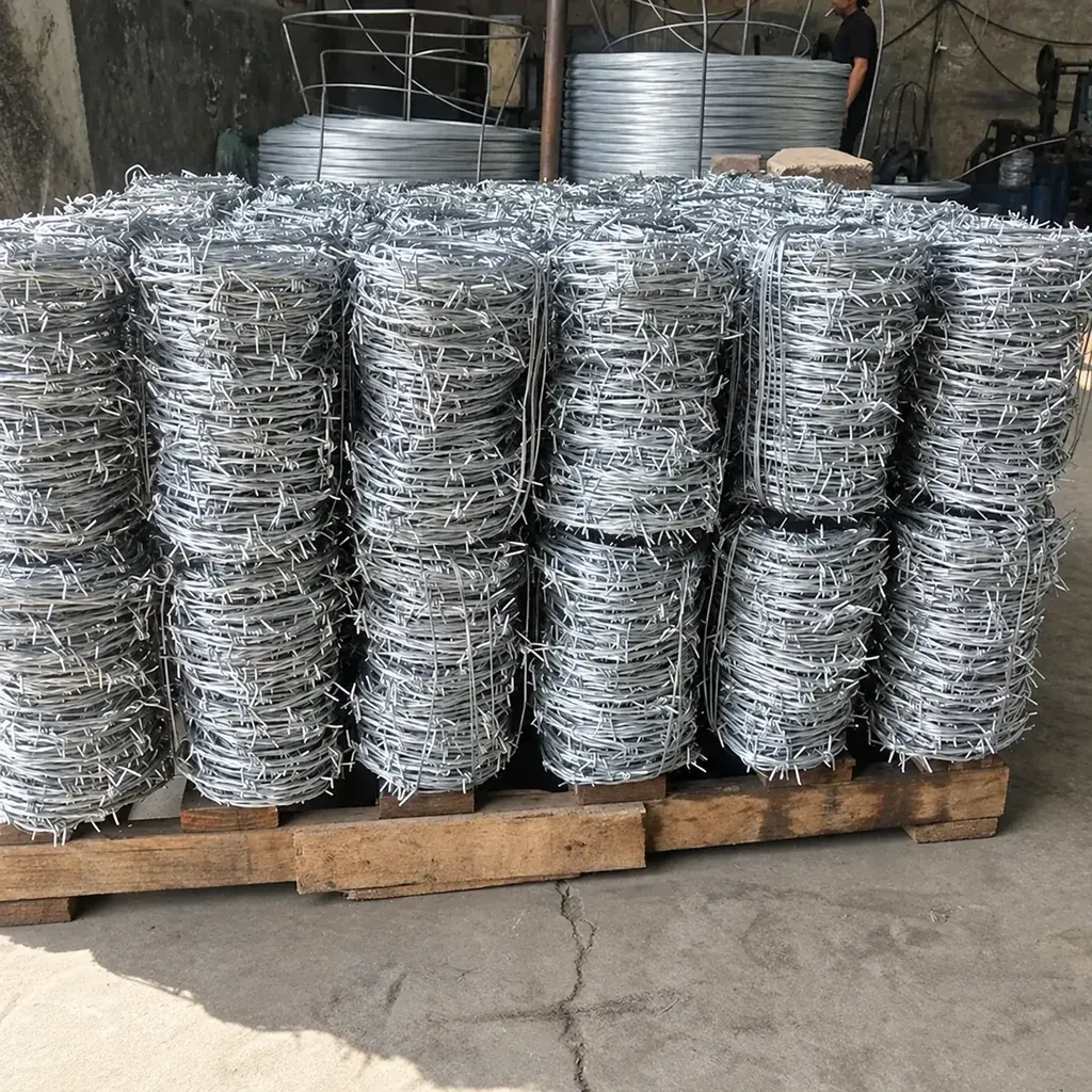 Stacks of galvanised barbed wire coils on a wooden pallet