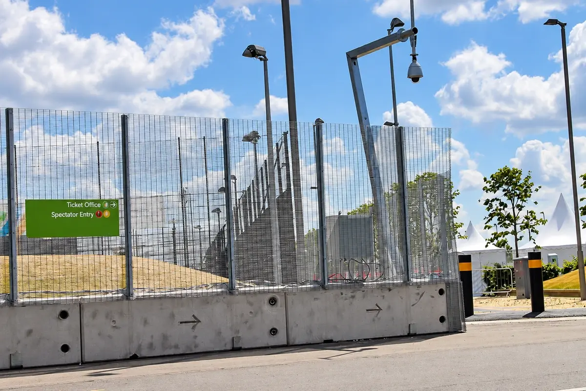 Security mesh boundary with a CCTV mast and controlled entrance