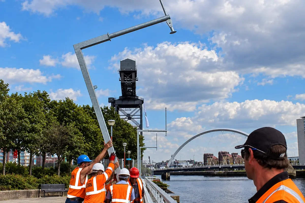 Installation crew raising a separate steel support for perimeter equipment