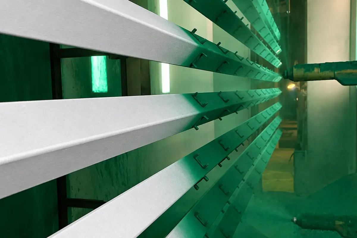 Steel fence posts suspended in a powder coating production line