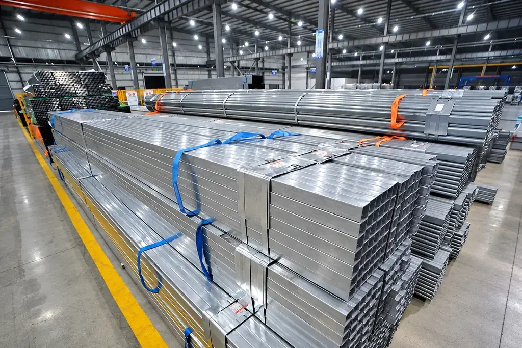 Bundled steel sections arranged on a workshop floor