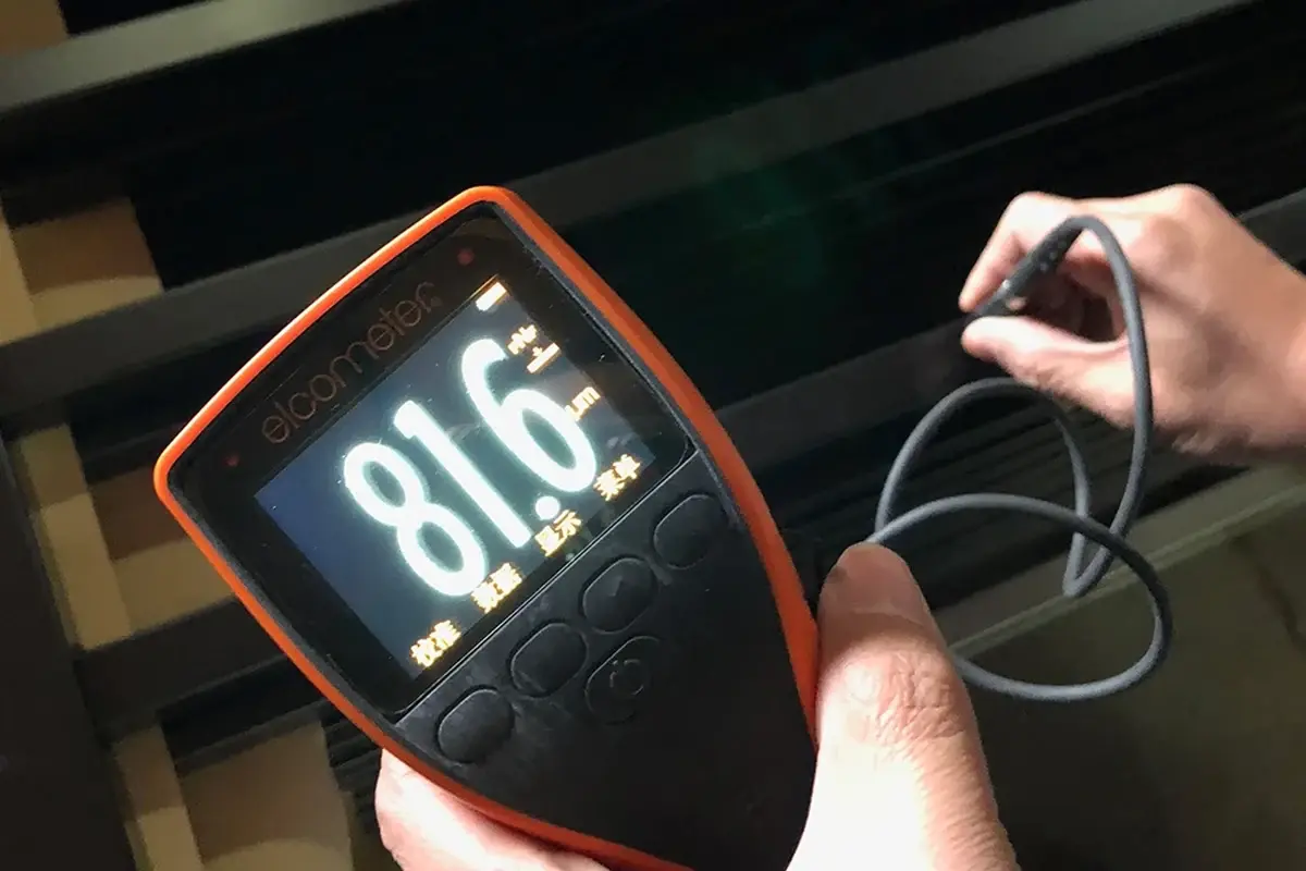 Coating thickness gauge checking a finished metal gate section